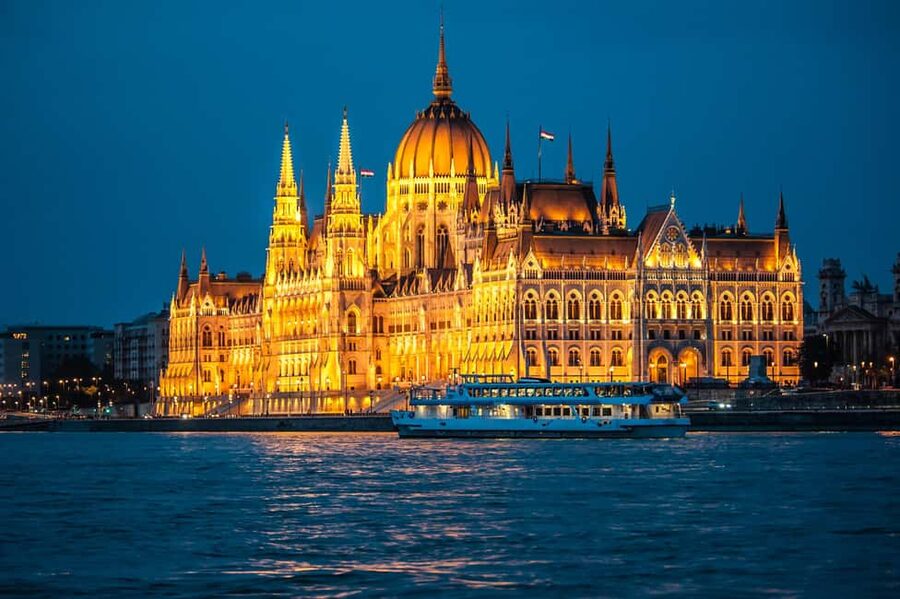 The Hungarian Parliament lit gold above the Danube after dark